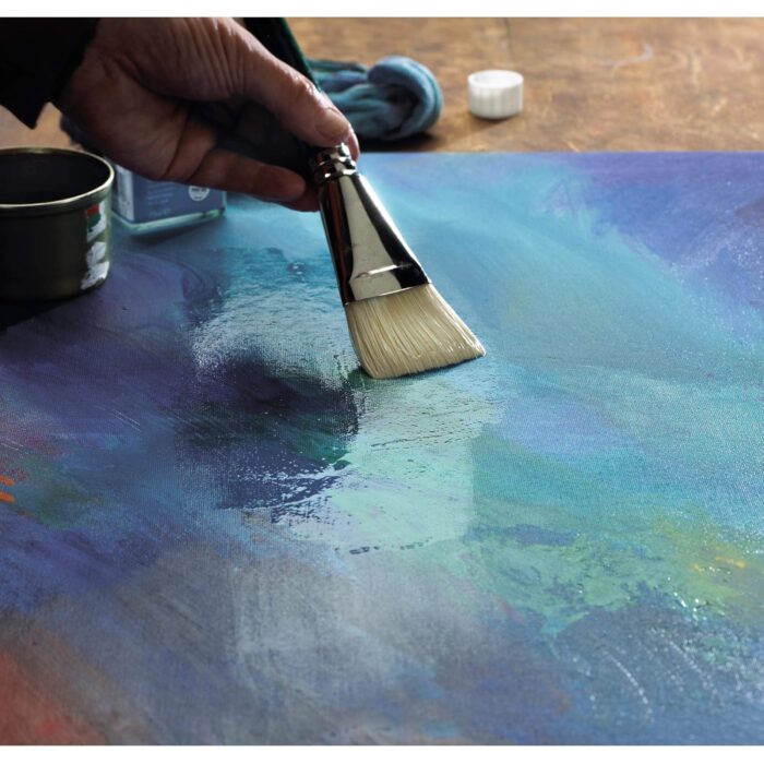 a hand holding a paint brush over a painting-Winsor & Newton General Purpose Matt Varnish Spray